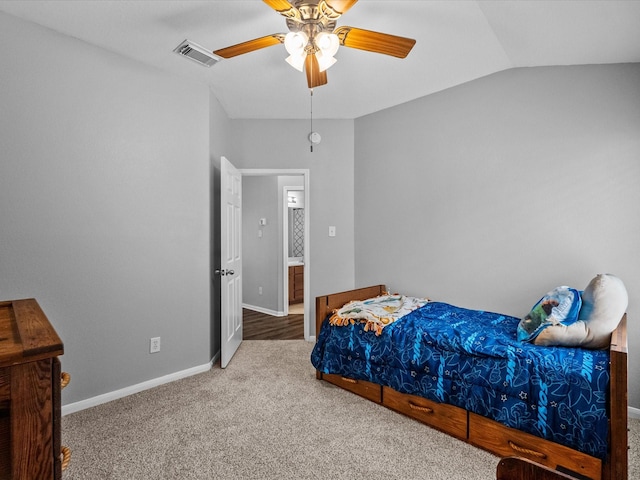 carpeted bedroom with visible vents, ceiling fan, baseboards, and vaulted ceiling