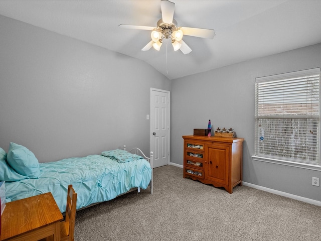 bedroom with light carpet, ceiling fan, baseboards, and vaulted ceiling