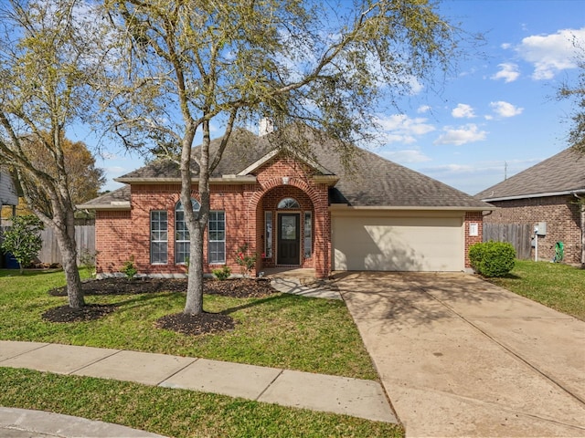 view of front of house with brick siding, a front lawn, fence, a garage, and driveway