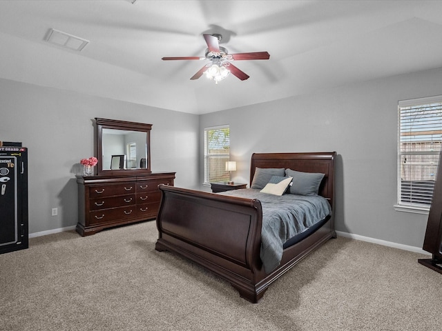 carpeted bedroom with visible vents, multiple windows, and baseboards