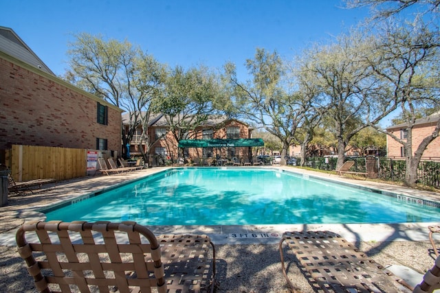 pool featuring a patio and fence