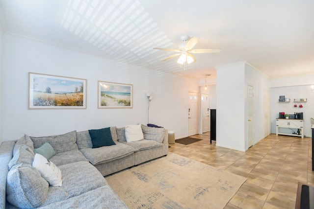 living room with light tile patterned floors, baseboards, a ceiling fan, and ornamental molding