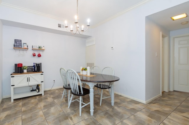 dining room with a notable chandelier, baseboards, visible vents, and ornamental molding