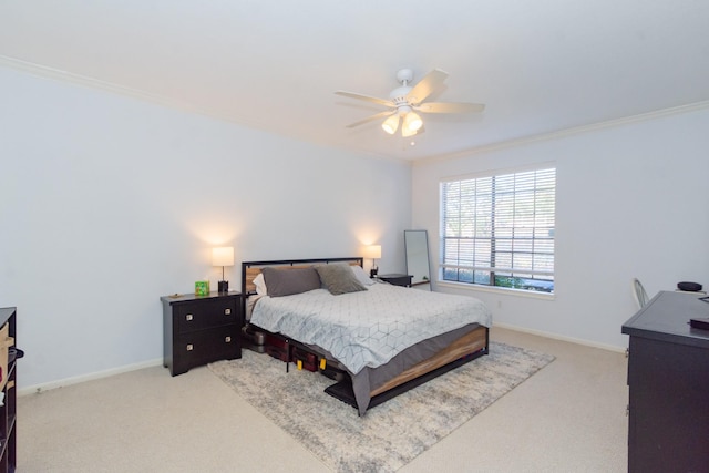 carpeted bedroom featuring ceiling fan, baseboards, and ornamental molding