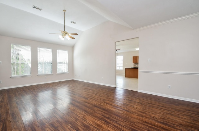 spare room with visible vents, dark wood-type flooring, ceiling fan, and vaulted ceiling