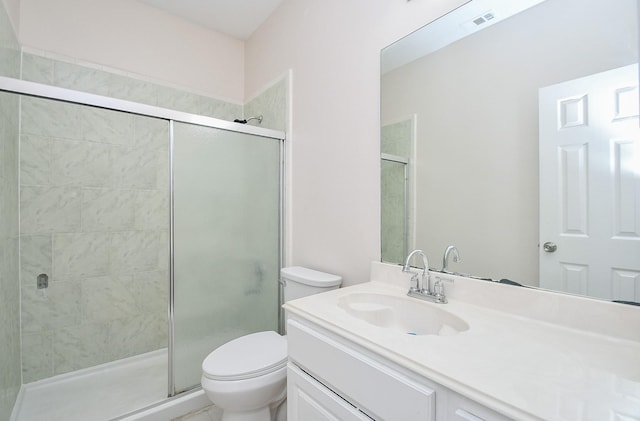 bathroom with vanity, toilet, visible vents, and a stall shower