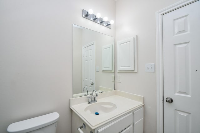 half bathroom featuring toilet and vanity