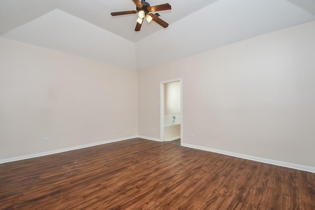 unfurnished room featuring dark wood finished floors, baseboards, ceiling fan, and vaulted ceiling