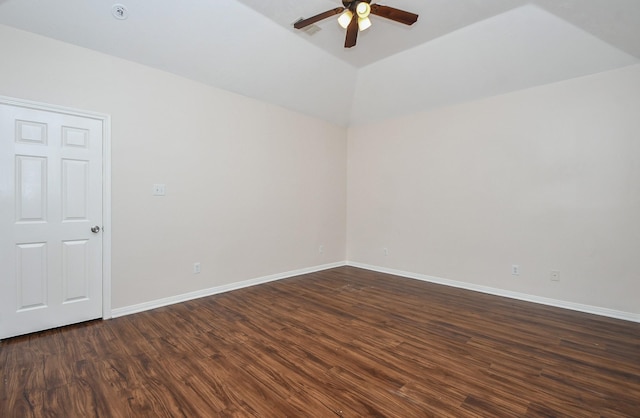 spare room featuring vaulted ceiling, baseboards, a ceiling fan, and dark wood-style flooring