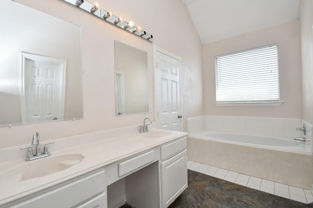 full bathroom featuring a sink, lofted ceiling, a bath, and double vanity