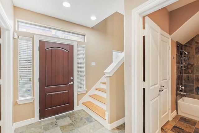 entryway with stairway, recessed lighting, and baseboards