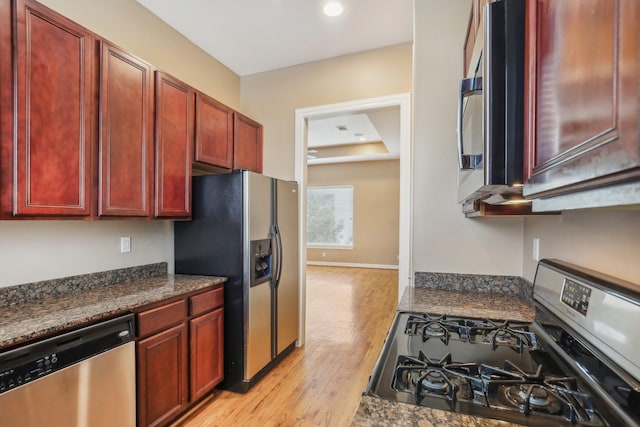 kitchen with dark brown cabinets, baseboards, recessed lighting, light wood-style flooring, and stainless steel appliances