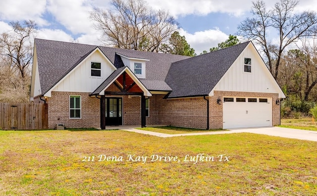 modern inspired farmhouse featuring a front yard, fence, brick siding, and board and batten siding