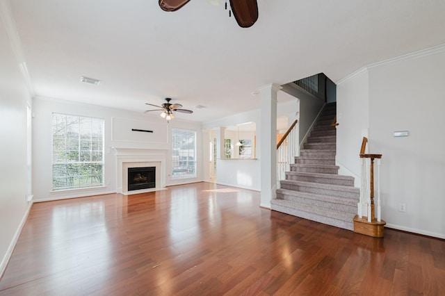 unfurnished living room featuring visible vents, wood finished floors, a ceiling fan, and stairway