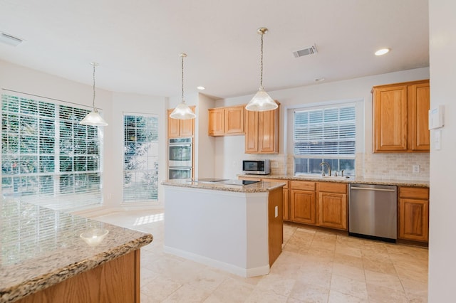 kitchen with tasteful backsplash, visible vents, appliances with stainless steel finishes, and a sink