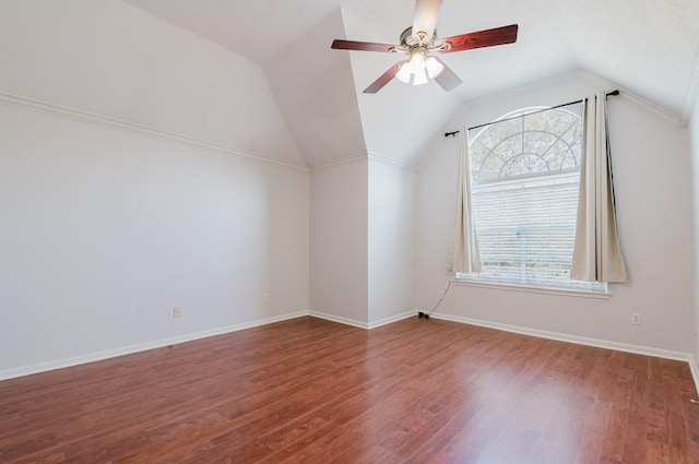 additional living space featuring vaulted ceiling, a ceiling fan, baseboards, and wood finished floors