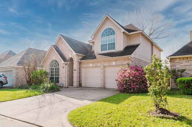 view of front of house featuring brick siding, an attached garage, concrete driveway, and a front yard