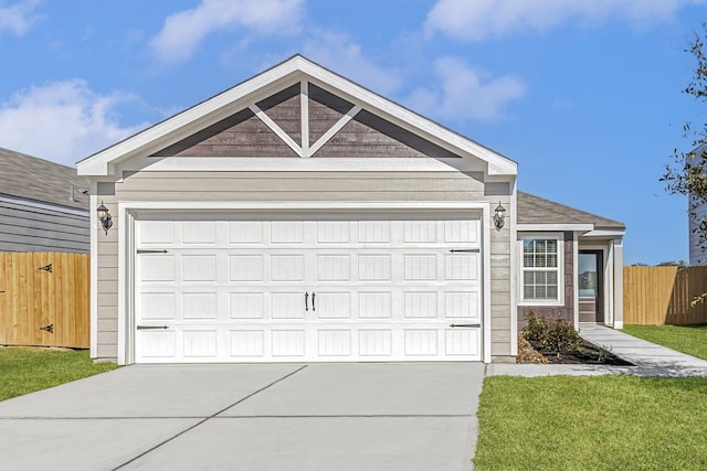 view of front of house featuring driveway and fence