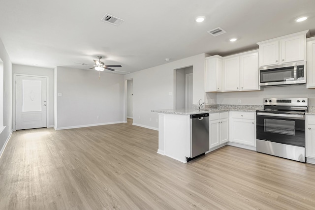 kitchen featuring a peninsula, a ceiling fan, visible vents, and appliances with stainless steel finishes