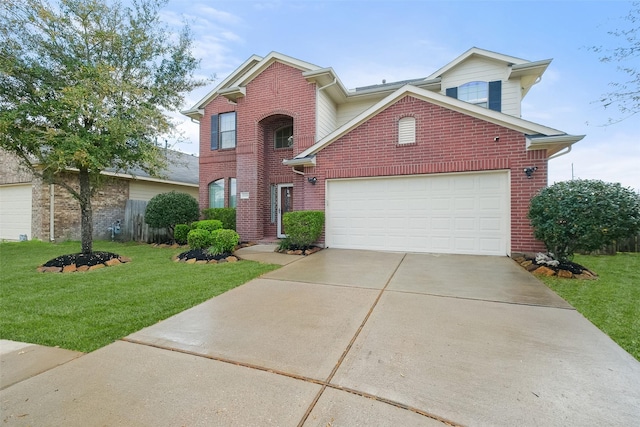 traditional-style house featuring brick siding, driveway, an attached garage, and a front yard