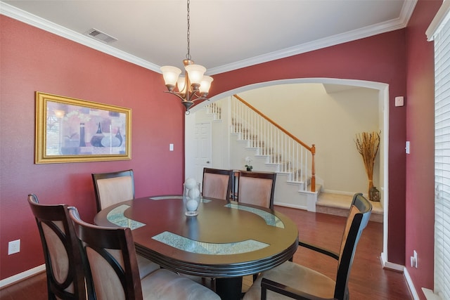 dining space with visible vents, wood finished floors, stairway, crown molding, and a chandelier