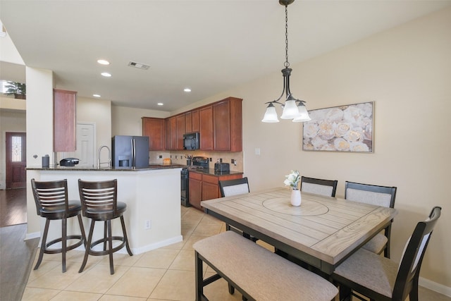 dining room with light tile patterned floors, visible vents, recessed lighting, and baseboards