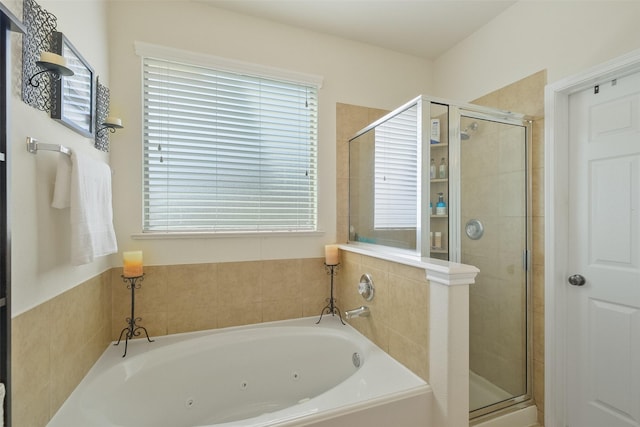 bathroom with a shower stall and a whirlpool tub