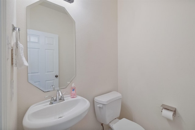 bathroom with toilet and a sink