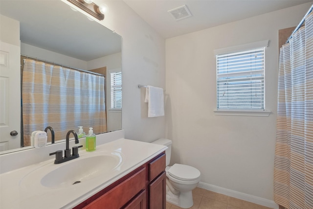 full bath with tile patterned floors, visible vents, plenty of natural light, and baseboards