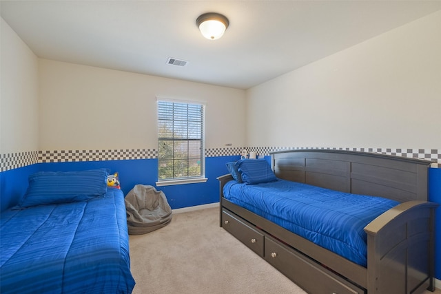 carpeted bedroom featuring visible vents and baseboards