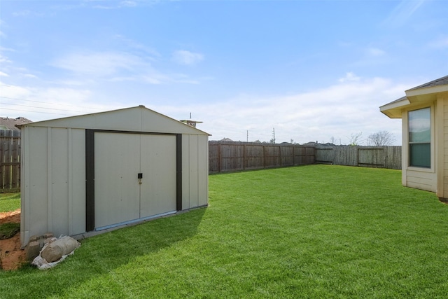 view of yard with a fenced backyard, an outdoor structure, and a shed