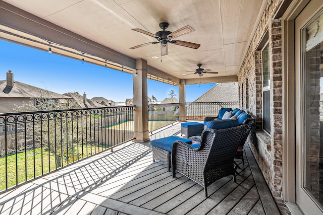 wooden deck with a ceiling fan