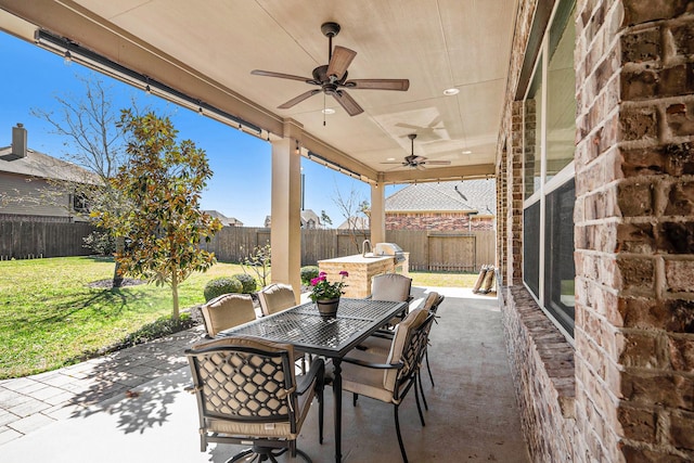 view of patio featuring a fenced backyard, outdoor dining area, and ceiling fan