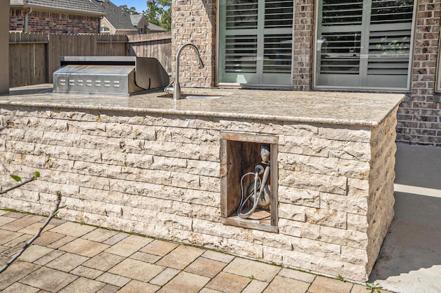 exterior details with a sink and fence