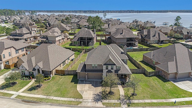 drone / aerial view with a residential view and a water view