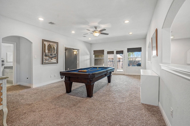 playroom featuring arched walkways, baseboards, light carpet, and ceiling fan