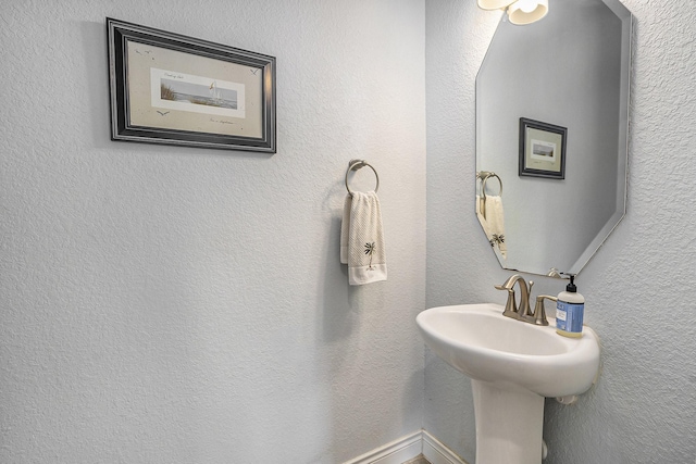 bathroom featuring a textured wall