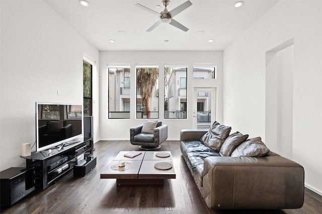 living area with a ceiling fan, recessed lighting, wood finished floors, and baseboards