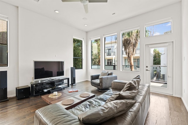 living area with recessed lighting, plenty of natural light, wood finished floors, and a ceiling fan