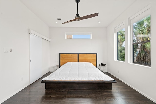 unfurnished bedroom featuring a ceiling fan, visible vents, baseboards, recessed lighting, and dark wood-style flooring