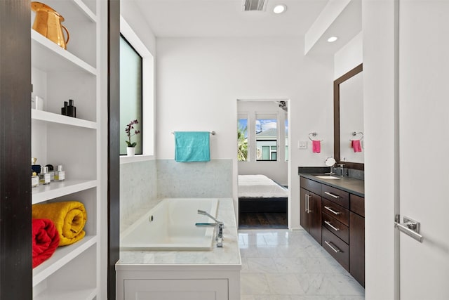 ensuite bathroom featuring visible vents, a garden tub, marble finish floor, connected bathroom, and vanity