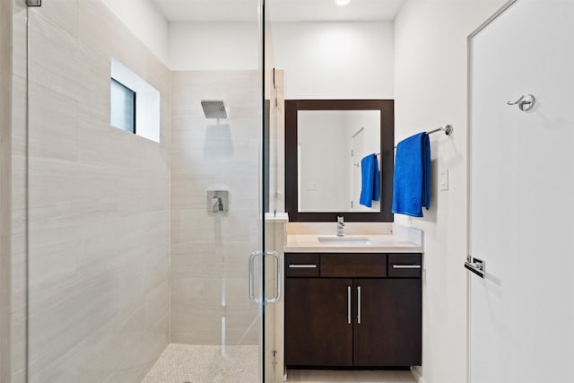 bathroom with a stall shower and vanity