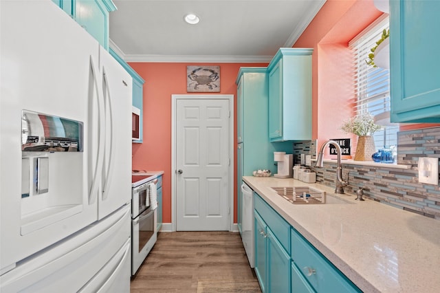 kitchen featuring backsplash, ornamental molding, white appliances, blue cabinets, and a sink