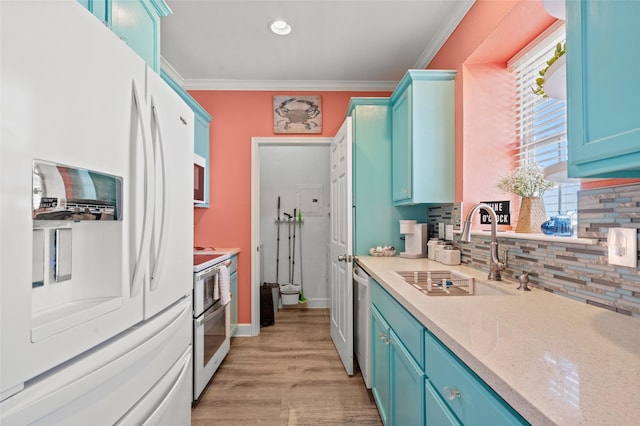 kitchen with blue cabinetry, a sink, white fridge with ice dispenser, dishwasher, and crown molding