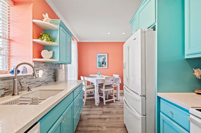 kitchen with a sink, open shelves, backsplash, white appliances, and light wood finished floors