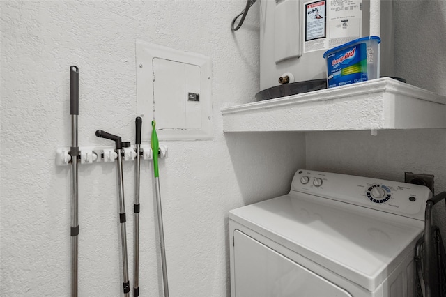 laundry area featuring washer / dryer, electric panel, a textured wall, and laundry area