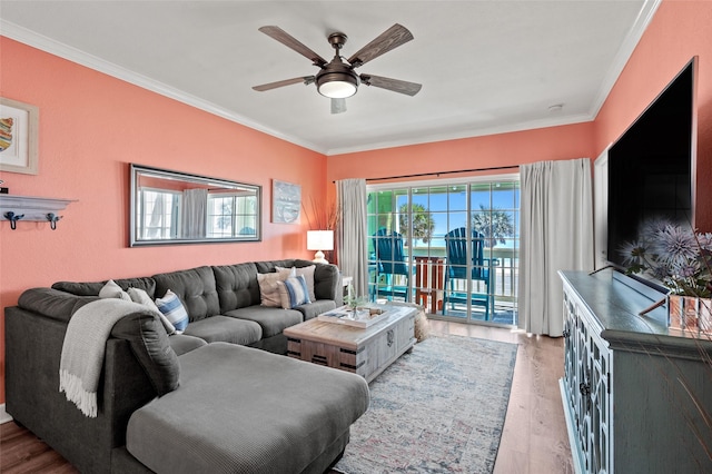 living room with crown molding, a ceiling fan, and wood finished floors