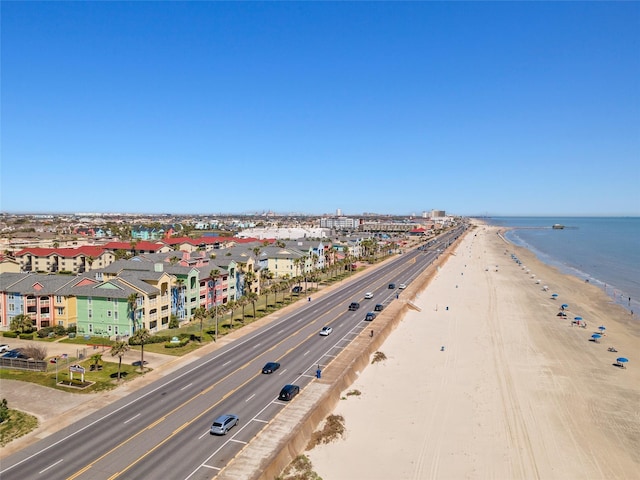 birds eye view of property featuring a beach view and a water view