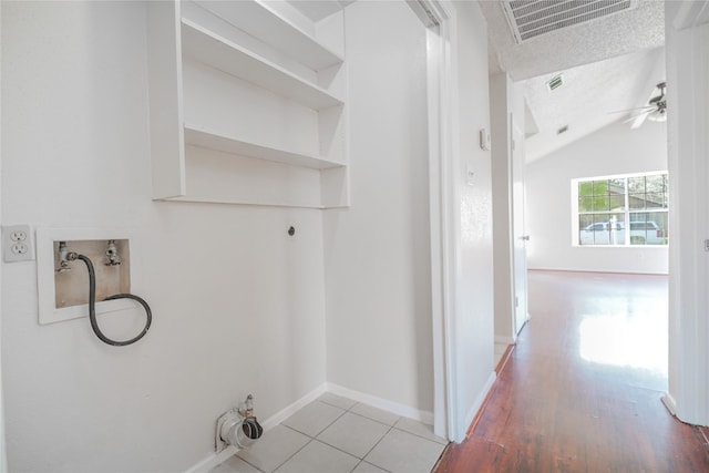 clothes washing area featuring visible vents, ceiling fan, laundry area, hookup for a washing machine, and light wood-style flooring