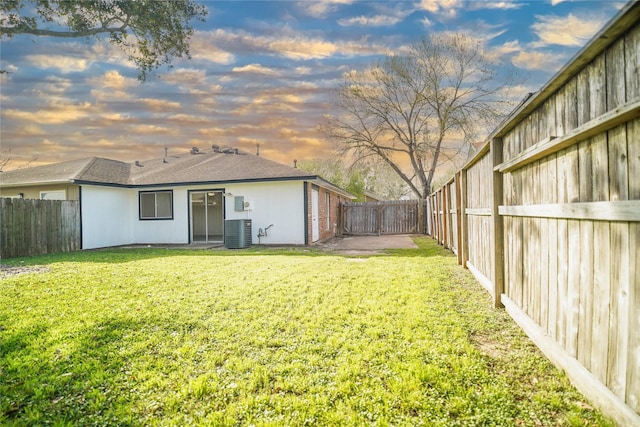 view of yard featuring central air condition unit and a fenced backyard